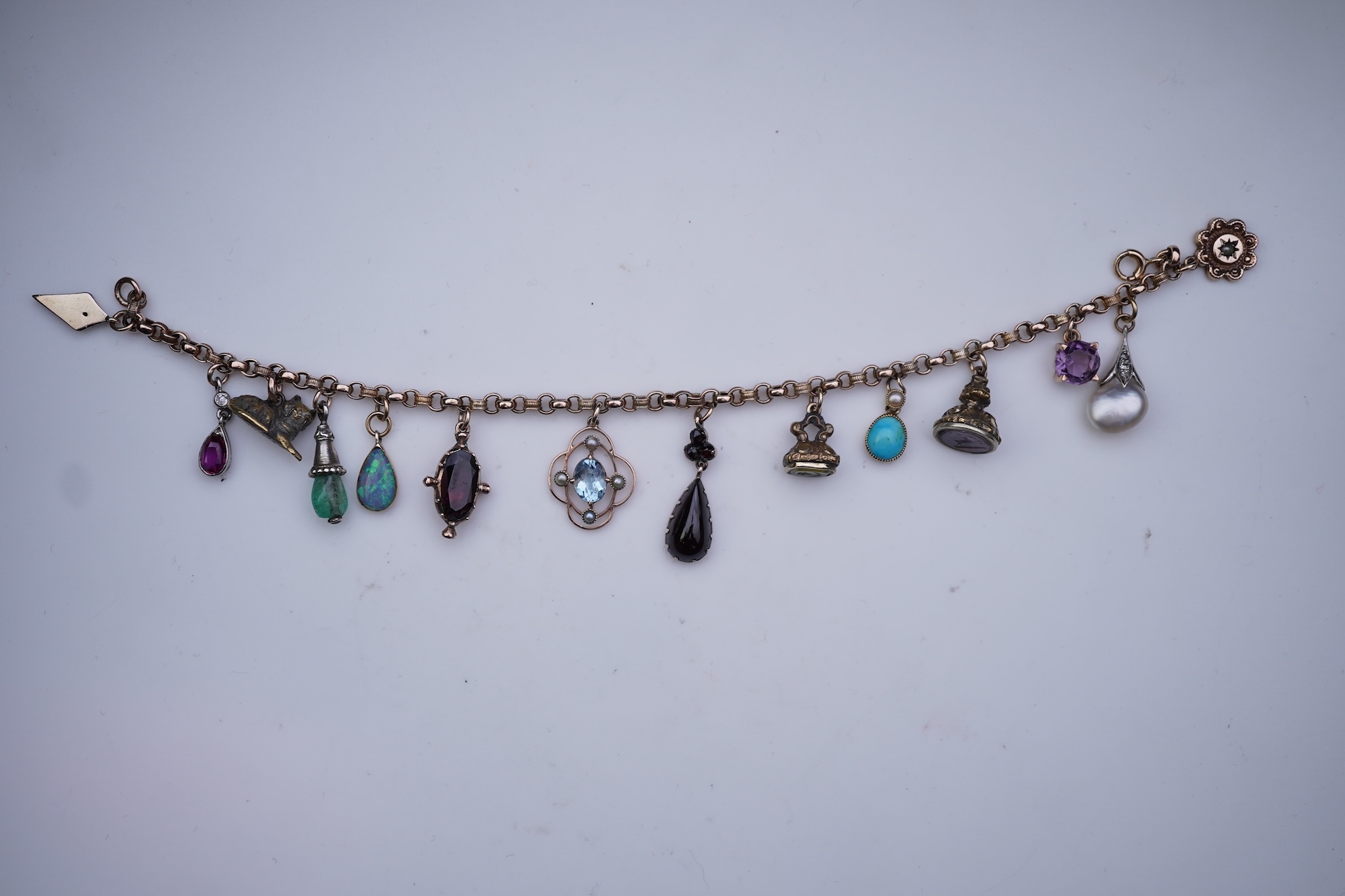 A gem-set charm bracelet, late 19th-early 20th century